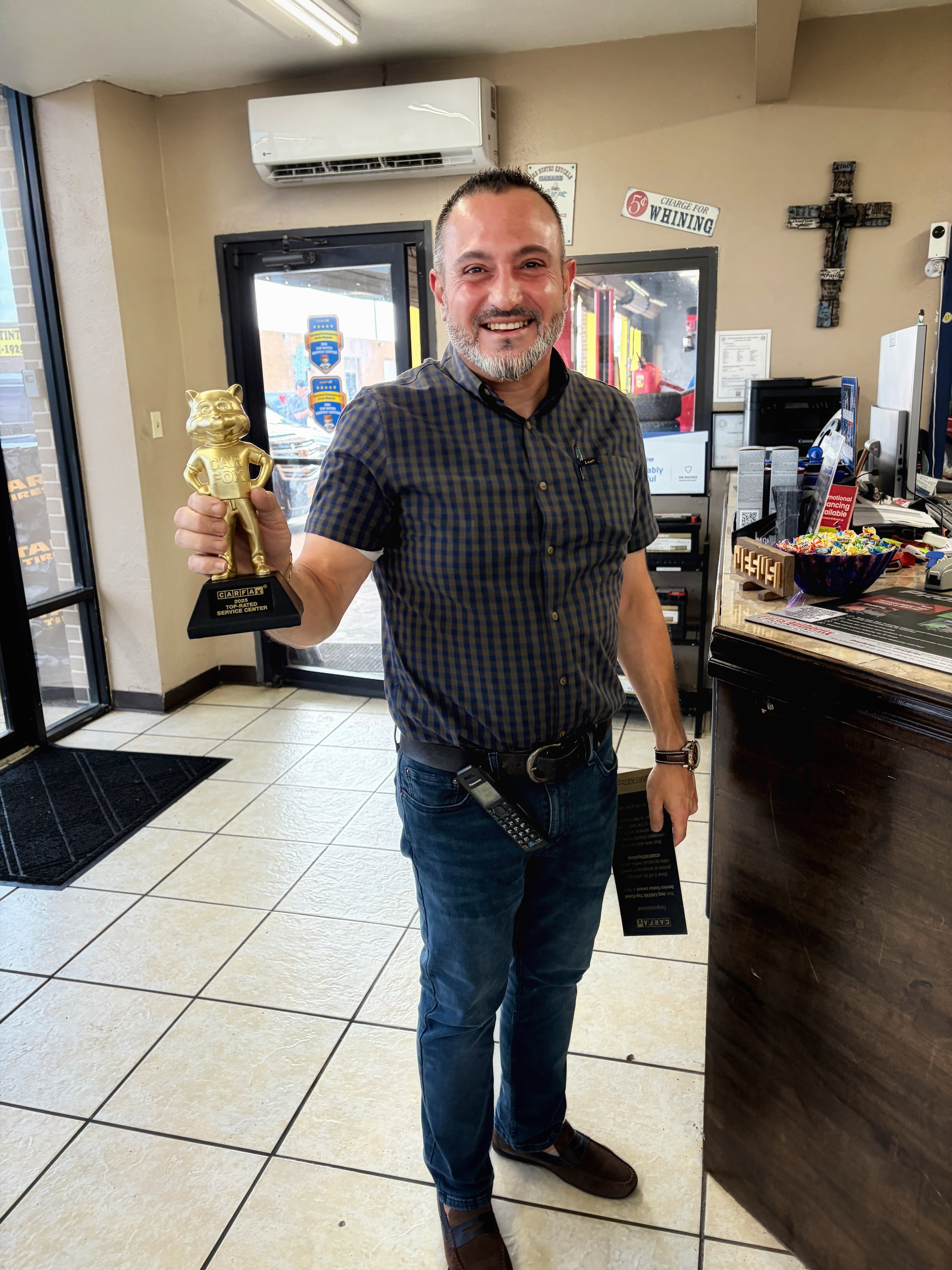 Tomball Goodyear owner holding the 2025 CARFAX Top-Rated Service Center award